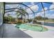 Screened in pool features a rock waterfall and scenic lake views at 5141 Riva Ridge Dr, Wesley Chapel, FL 33544
