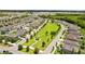 Beautiful aerial view of a planned community with a large green common area, sidewalks, and well-maintained landscaping at 5170 Sea Mist Ln, Wesley Chapel, FL 33545