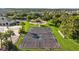 Aerial view showcasing the community basketball court, nestled near the pool and lush landscaping at 5170 Sea Mist Ln, Wesley Chapel, FL 33545