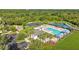 Aerial view of the community pool, clubhouse, basketball court, and amenities, nestled amongst lush green landscape at 5170 Sea Mist Ln, Wesley Chapel, FL 33545