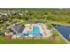 Aerial view of the community pool, clubhouse, pond, basketball court, and green spaces within the neighborhood at 5170 Sea Mist Ln, Wesley Chapel, FL 33545