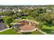Aerial view showcases the community playground bordered with green space and trees at 5170 Sea Mist Ln, Wesley Chapel, FL 33545