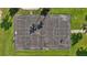 Aerial view of the community basketball court with clearly marked lines and hoops, surrounded by green grass at 5170 Sea Mist Ln, Wesley Chapel, FL 33545