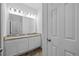 Bathroom featuring double sinks with granite counters and a white cabinet at 5170 Sea Mist Ln, Wesley Chapel, FL 33545