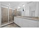 Bathroom featuring double sinks, granite countertops, and walk-in shower at 5170 Sea Mist Ln, Wesley Chapel, FL 33545