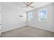 Light and airy bedroom featuring neutral carpet, a ceiling fan, and windows with a view at 5170 Sea Mist Ln, Wesley Chapel, FL 33545