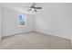Bright bedroom with neutral carpet, a ceiling fan, and a window at 5170 Sea Mist Ln, Wesley Chapel, FL 33545