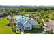 A stylish clubhouse overlooks a community pool and a splashpad play area, surrounded by lush greenery at 5170 Sea Mist Ln, Wesley Chapel, FL 33545