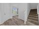 Bright entryway with wood floors, stairs, and a view into another room at 5170 Sea Mist Ln, Wesley Chapel, FL 33545