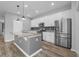 Modern kitchen featuring stainless steel appliances, granite countertops, and white cabinetry at 5170 Sea Mist Ln, Wesley Chapel, FL 33545