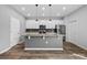 Bright, modern kitchen with granite countertops, stainless steel appliances, and center island at 5170 Sea Mist Ln, Wesley Chapel, FL 33545