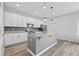 Spacious kitchen with white cabinets, granite counters, stainless appliances, and center island at 5170 Sea Mist Ln, Wesley Chapel, FL 33545