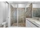 Shower featuring a glass door and neutral tile at 5170 Sea Mist Ln, Wesley Chapel, FL 33545