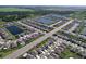 An aerial view of a Primary-planned community featuring numerous homes, serene ponds, and lush green spaces at 5470 Flint Hills Dr, Wimauma, FL 33598