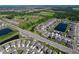 Beautiful aerial view showcasing community homes bordering long ponds and expansive green space at 5470 Flint Hills Dr, Wimauma, FL 33598