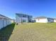 Spacious backyard featuring lush green grass and a sturdy privacy fence, perfect for outdoor activities and relaxation at 5470 Flint Hills Dr, Wimauma, FL 33598