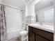Cozy bathroom featuring a shower-tub combo with a sleek white vanity and neutral accents at 5470 Flint Hills Dr, Wimauma, FL 33598