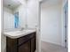 Bathroom featuring a dark vanity, and neutral walls with a mirror at 5470 Flint Hills Dr, Wimauma, FL 33598