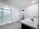 Bathroom featuring a walk-in shower and a double vanity with granite countertops at 5470 Flint Hills Dr, Wimauma, FL 33598