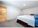 Spacious bedroom featuring carpet floors, neutral paint and a decorative wooden-framed bed at 5470 Flint Hills Dr, Wimauma, FL 33598