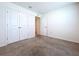 Spacious bedroom with neutral carpet, white walls, and a closet for ample storage at 5470 Flint Hills Dr, Wimauma, FL 33598