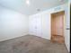 Bright bedroom featuring neutral carpet, white walls, and an entrance to a walk-in closet at 5470 Flint Hills Dr, Wimauma, FL 33598