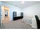 Bedroom with carpet, a bed and dresser, built in shelving, and an open hallway at 5470 Flint Hills Dr, Wimauma, FL 33598
