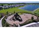 Aerial view of the community playground featuring slides, swings, and ample space for outdoor activities at 5470 Flint Hills Dr, Wimauma, FL 33598