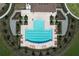 Aerial view of the community pool with lounge chairs and landscaping, perfect for relaxation and recreation at 5470 Flint Hills Dr, Wimauma, FL 33598