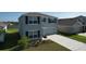 Two-story home with a two-car garage and neutral exterior paint at 5470 Flint Hills Dr, Wimauma, FL 33598