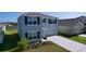 Beautiful two-story home with a well-maintained lawn, and a two car garage, offering comfort and style at 5470 Flint Hills Dr, Wimauma, FL 33598