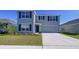 Charming two-story home with a well-manicured lawn and an attached two-car garage in a Gathering-friendly neighborhood at 5470 Flint Hills Dr, Wimauma, FL 33598