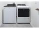 Laundry room featuring a modern washer and dryer and tiled flooring at 5470 Flint Hills Dr, Wimauma, FL 33598