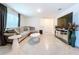 Spacious living room features a comfortable couch, modern decor and tile flooring at 5470 Flint Hills Dr, Wimauma, FL 33598