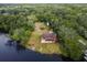 Aerial view of a two-story waterfront home with a deck overlooking the tranquil river at 5832 Portal Rd, New Port Richey, FL 34655