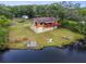 Two-story waterfront home with a red deck, ready for your personal touch and transformation at 5832 Portal Rd, New Port Richey, FL 34655