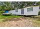 Exterior view of a mobile home with a boat and trailer parked nearby at 5832 Portal Rd, New Port Richey, FL 34655