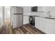 Modern kitchen features stainless steel appliances and white cabinetry at 5832 Portal Rd, New Port Richey, FL 34655