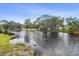 Scenic waterfront view with lush greenery and tranquil waters, perfect for nature lovers at 5832 Portal Rd, New Port Richey, FL 34655