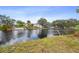 Beautiful waterfront view of lush greenery with homes along a tranquil river at 5832 Portal Rd, New Port Richey, FL 34655