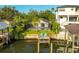 Relaxing backyard oasis with screened-in pool, lush landscaping, and private dock on the water at 593 Marmora Ave, Tampa, FL 33606