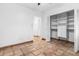 Light and airy bedroom boasts neutral walls, tile flooring, and closet with built-in shelving at 593 Marmora Ave, Tampa, FL 33606