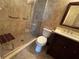 Updated bathroom featuring tiled walk-in shower with glass door, toilet, and vanity at 750 Island Way # 101, Clearwater Beach, FL 33767