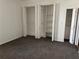 Bedroom with neutral carpet and white walls, enhanced by ample closet space for organization at 750 Island Way # 101, Clearwater Beach, FL 33767