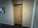 Apartment door number 101 in a neutral hallway with dark floors and a bulletin board at 750 Island Way # 101, Clearwater Beach, FL 33767