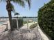 Community pool area with lush landscaping and beautiful bay views at 750 Island Way # 101, Clearwater Beach, FL 33767