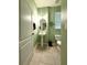 Bathroom features a pedestal sink, toilet, and neutral tile flooring at 7543 Red Mill Circle Cir, New Port Richey, FL 34653