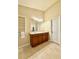 Bright bathroom featuring a double sink vanity, large mirror, and modern lighting at 7543 Red Mill Circle Cir, New Port Richey, FL 34653