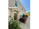 Well-kept townhouse exterior with tidy landscaping, a covered entryway, and large windows at 7543 Red Mill Circle Cir, New Port Richey, FL 34653