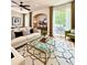 Bright and airy living room with modern decor, a glass coffee table, and a sliding door at 7543 Red Mill Circle Cir, New Port Richey, FL 34653